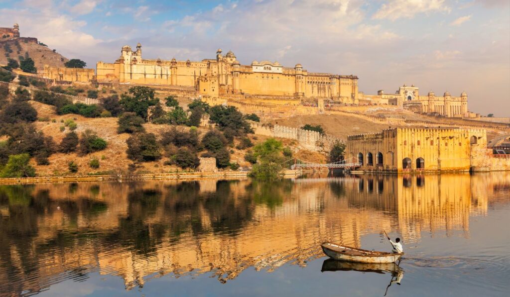 Scenic view of Amber Fort in Jaipur reflected in Maota Lake, one of the top attractions included in the Golden Triangle Tour of India.